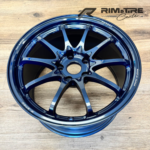RAYS ENGINEERING VOLK RACING TE37 SAGA M-SPEC forged wheel rim in a stunning metallic blue finish displayed on a wooden floor highlighting its sleek multi-spoke design and Made in Japan inscription