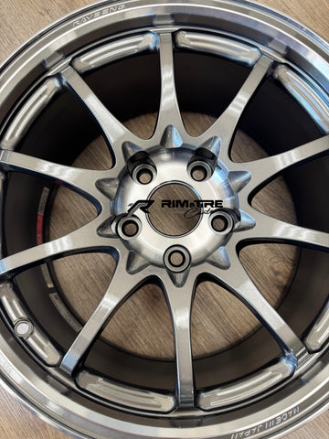 RAYS ENGINEERING multi-spoke wheel in glossy light silver finish displaying a 5-lug bolt pattern and MADE IN JAPAN etching on a light wood floor