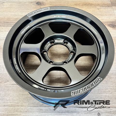 Volk Racing RAYS Engineering forged TE37 alloy wheel in matte gunmetal finish featuring an iconic six-spoke design and 'MADE IN JAPAN' text on a light wood floor
